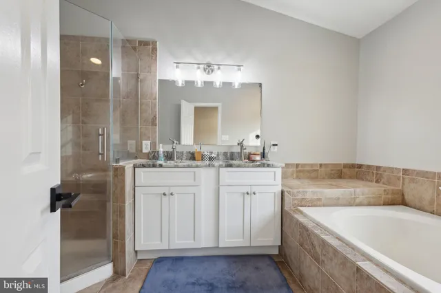 a spacious bedroom with a bed and a dresser