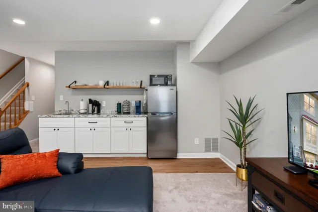 a view of kitchen with furniture and wooden floor
