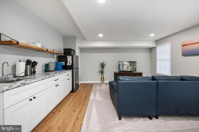 a living room with furniture and a potted plant