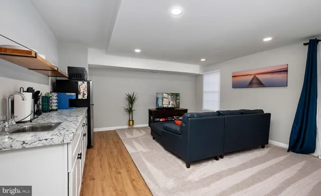 a kitchen with granite countertop a refrigerator and a stove top oven