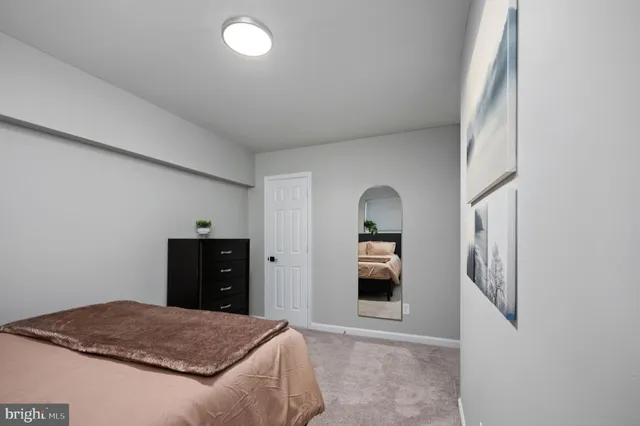 a bedroom with a bed and a dresser