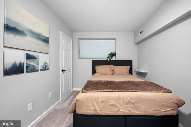 a bedroom with a bed and a dresser