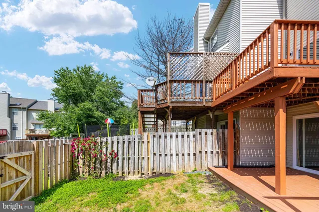 a view of a house with wooden fence