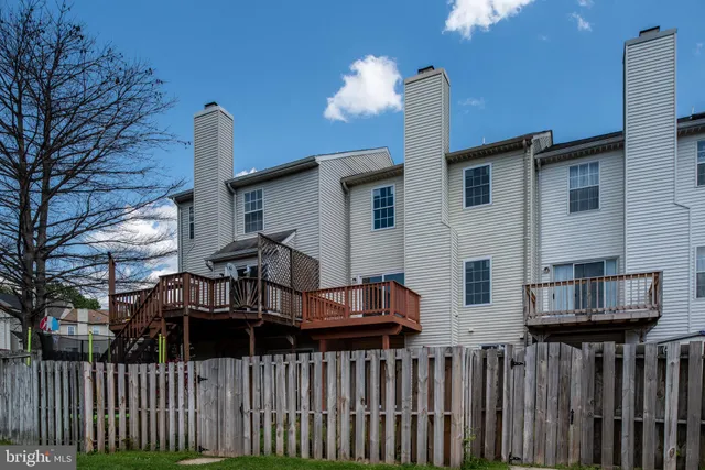a view of a house with wooden fence