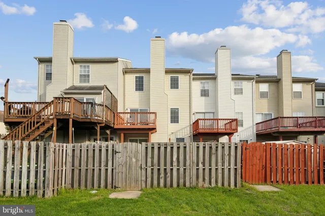 a couple of cars parked in front of a house
