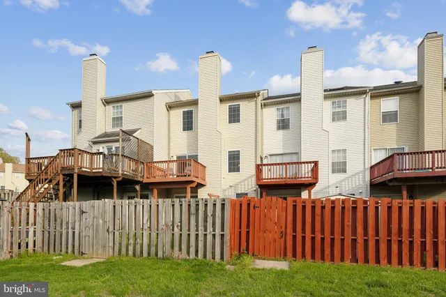 a view of a house with wooden fence