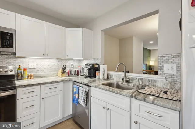 a kitchen with sink and cabinets