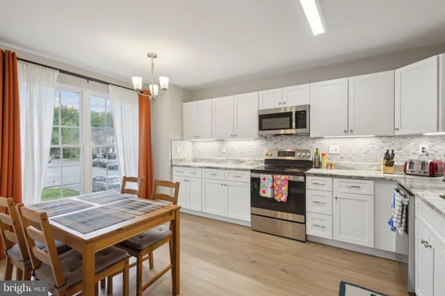 a kitchen with a stove a sink and a refrigerator