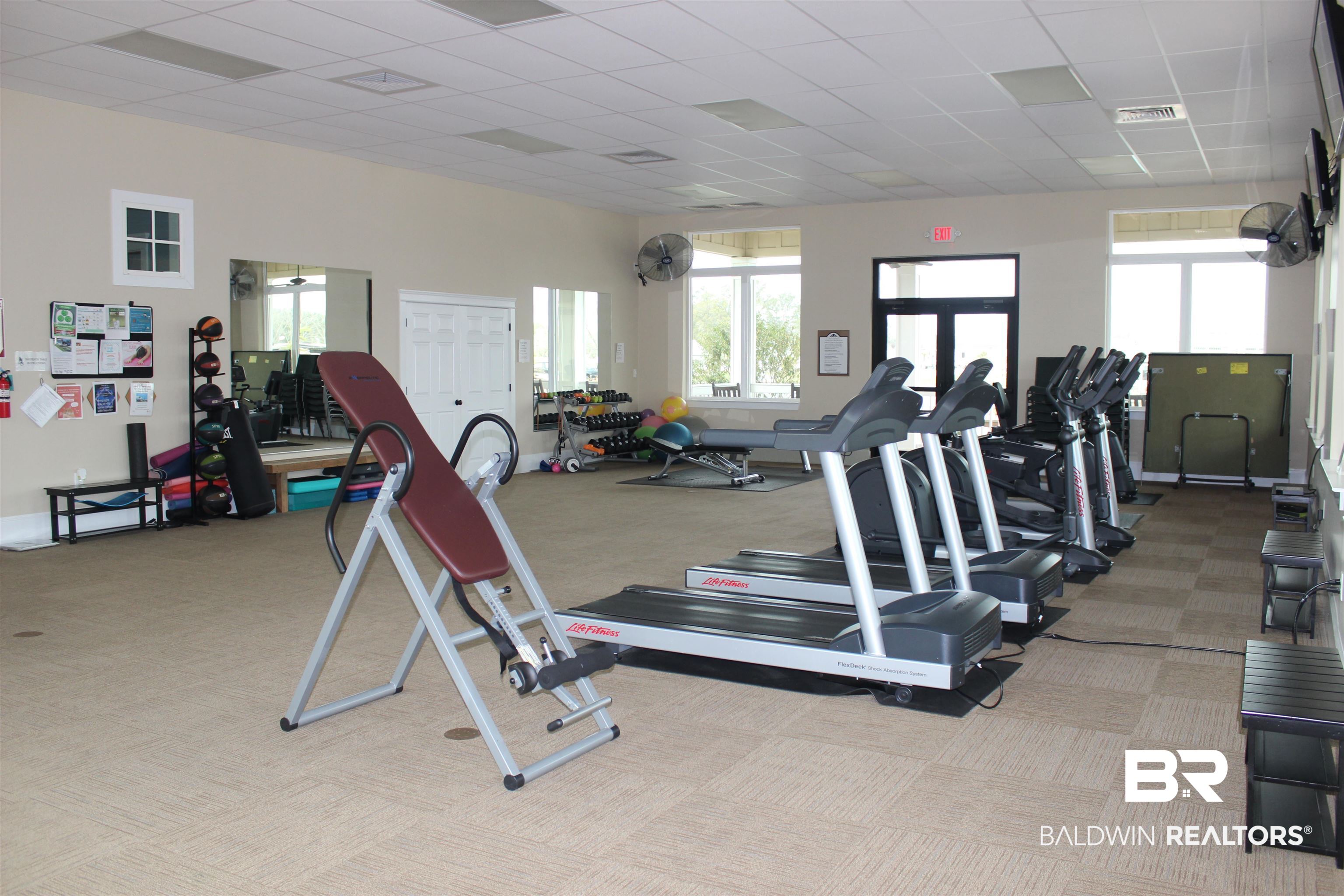 11869 Gateway Drive Elberta, AL 36530 - Photo 23 of 78 Gym featuring visible vents, carpet, and a healthy amount of sunlight