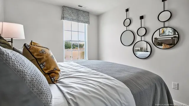 a bedroom with a bed and a window