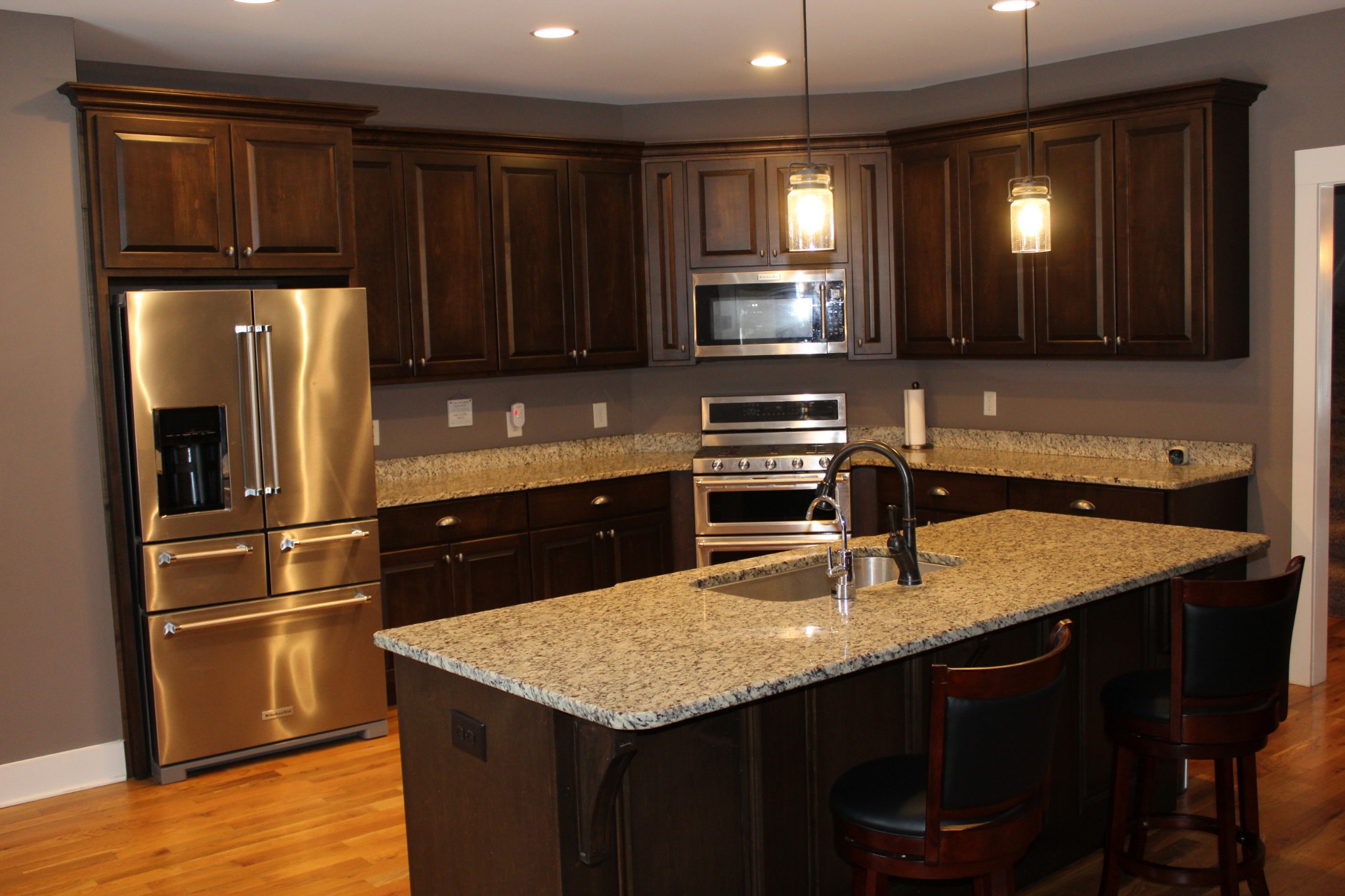 1271 Fall Creek Road Lebanon, TN 37090 - Photo 4 of 10 a kitchen with stainless steel appliances granite countertop a sink refrigerator and microwave