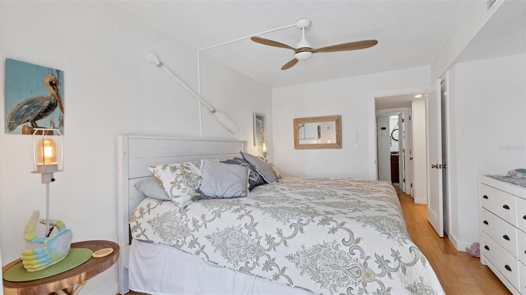 9200 Midnight Pass Road, Unit 24 Sarasota, FL 34242 - Photo 23 of 43 a bedroom with a bed and a dresser