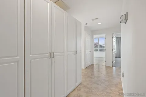 a view of a hallway with white doors