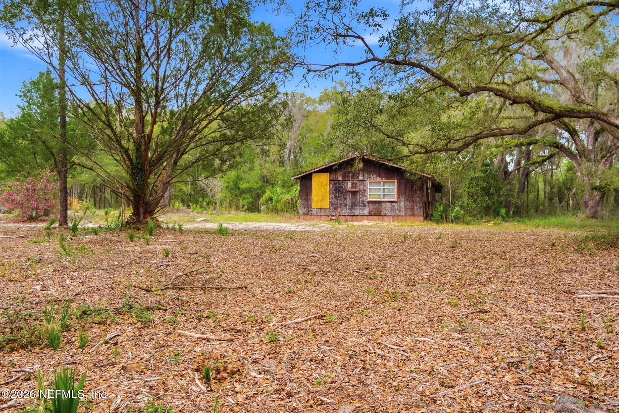660 Old Welaka Road Satsuma, FL 32189 - Photo 7 of 28 a house with trees in front of it