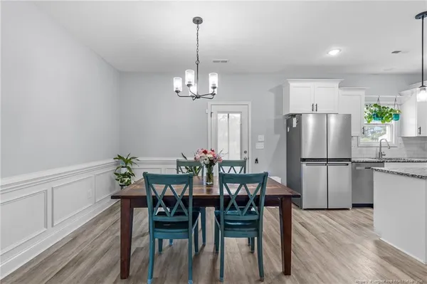 a view of a dining room with furniture and wooden floor