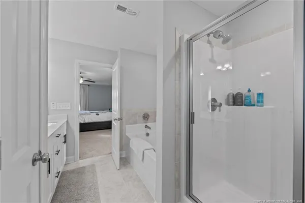 a bathroom with a glass door shower a sink and a mirror