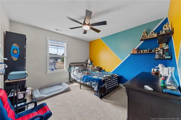 a bedroom with furniture and a window