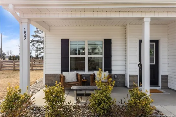 a front view of a house with outdoor seating and plants