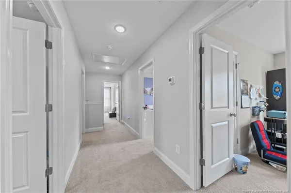 a view of hallway with livingroom and furniture