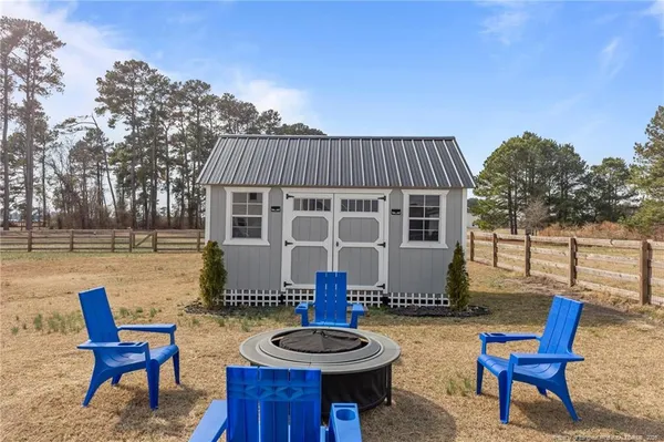 a view of a house with backyard and sitting area