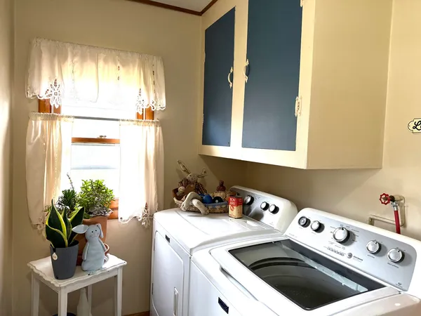 a kitchen with a white stove top oven and white cabinets
