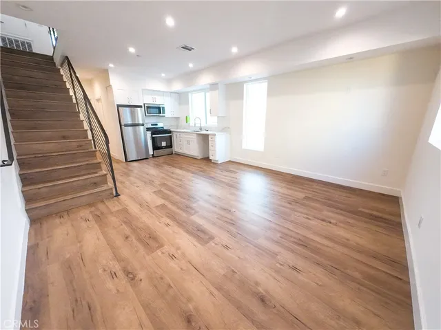 a view of kitchen and wooden floor