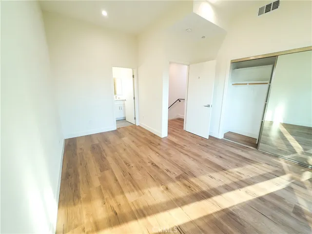 a bedroom with a bed and a mirror