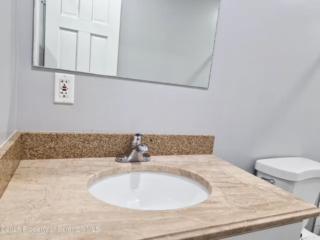 an empty room with wooden floor and window