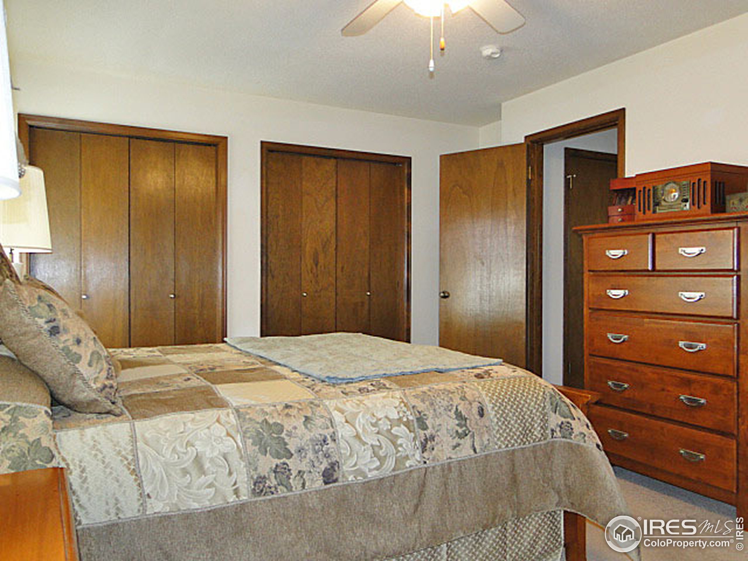 3334 34th Street Greeley, CO 80634 - Photo 12 of 25 a bedroom with a bed and a dresser