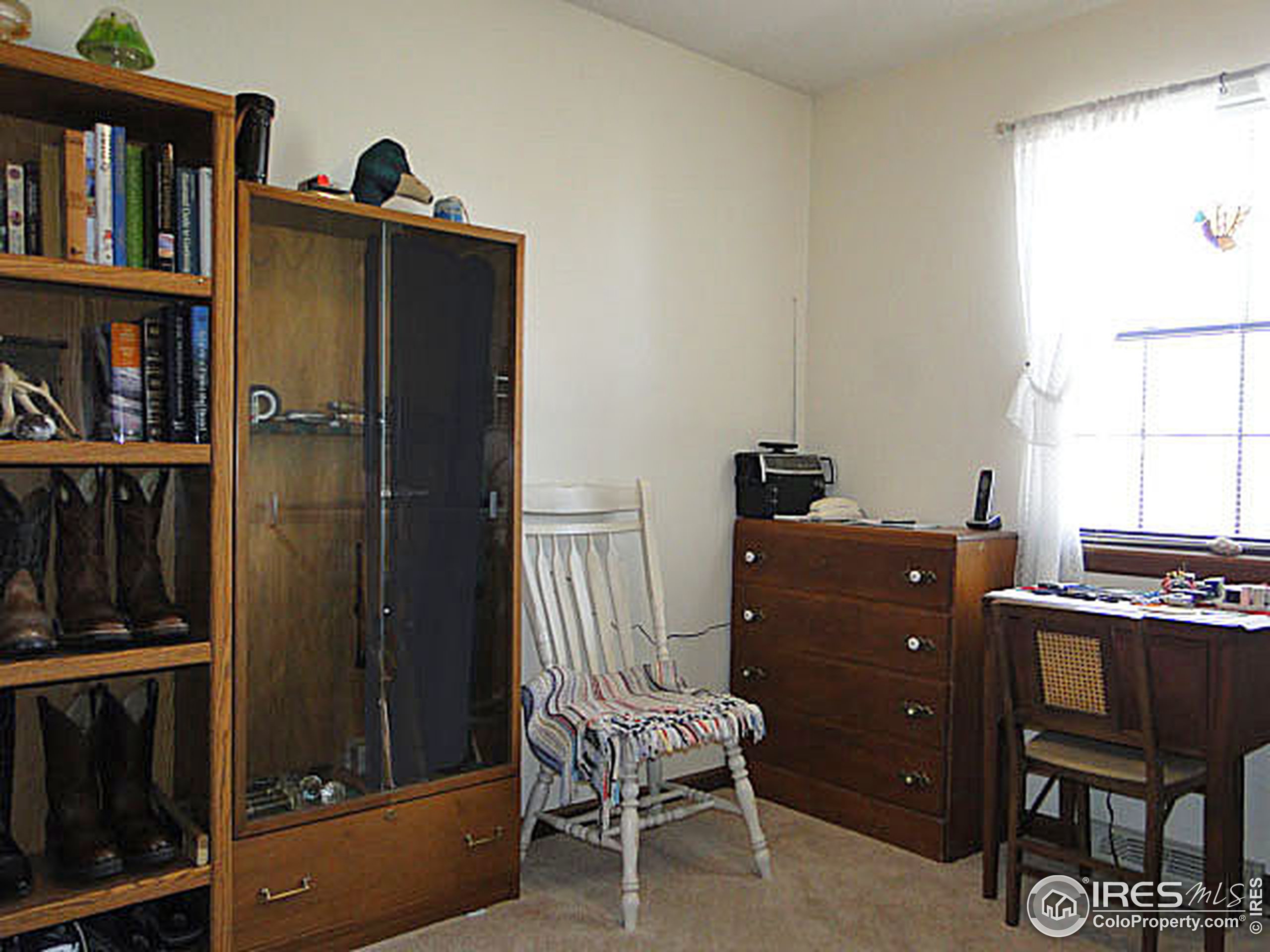3334 34th Street Greeley, CO 80634 - Photo 14 of 25 a room with a window closet and a chair