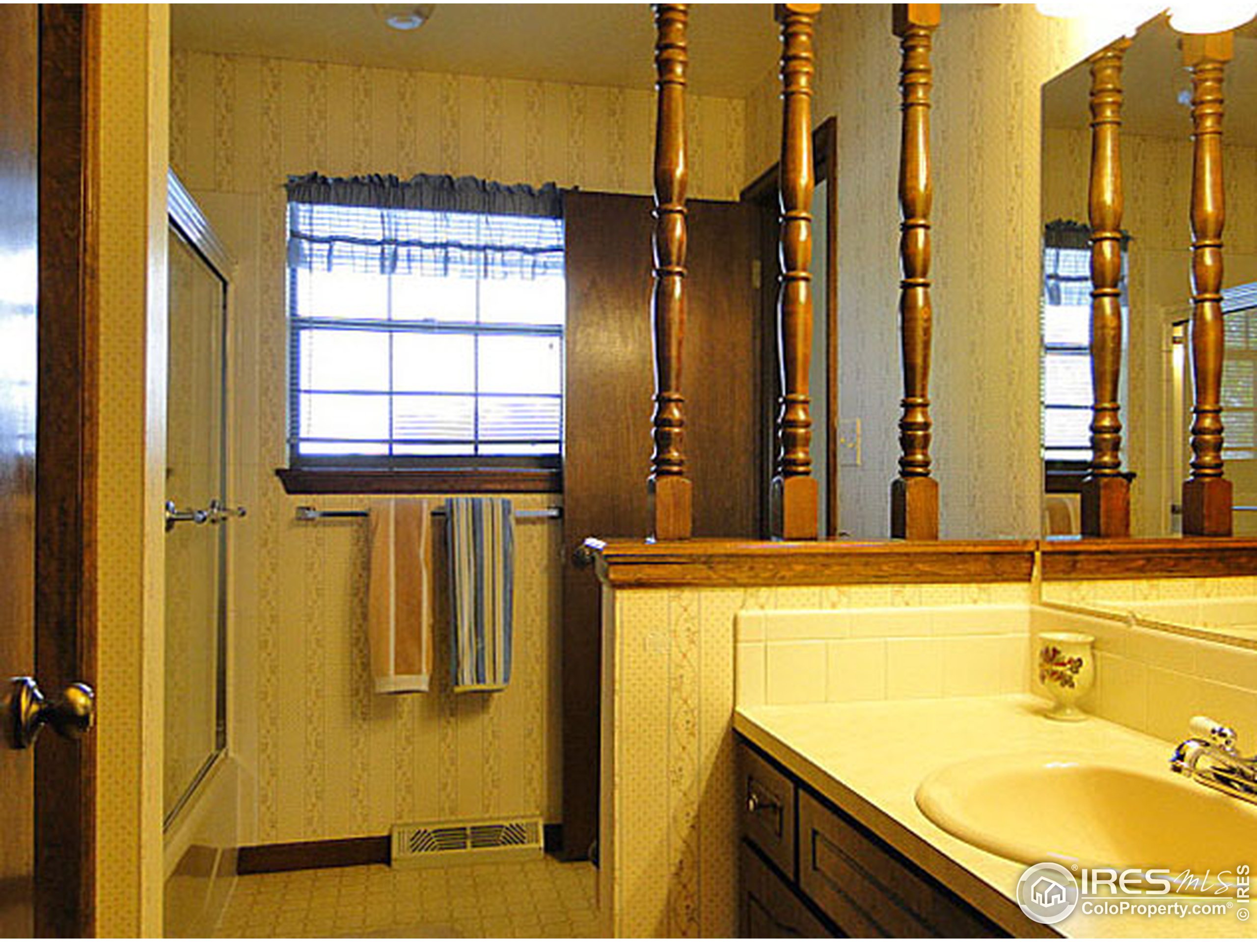 3334 34th Street Greeley, CO 80634 - Photo 15 of 25 a bathroom with a granite countertop sink and a mirror