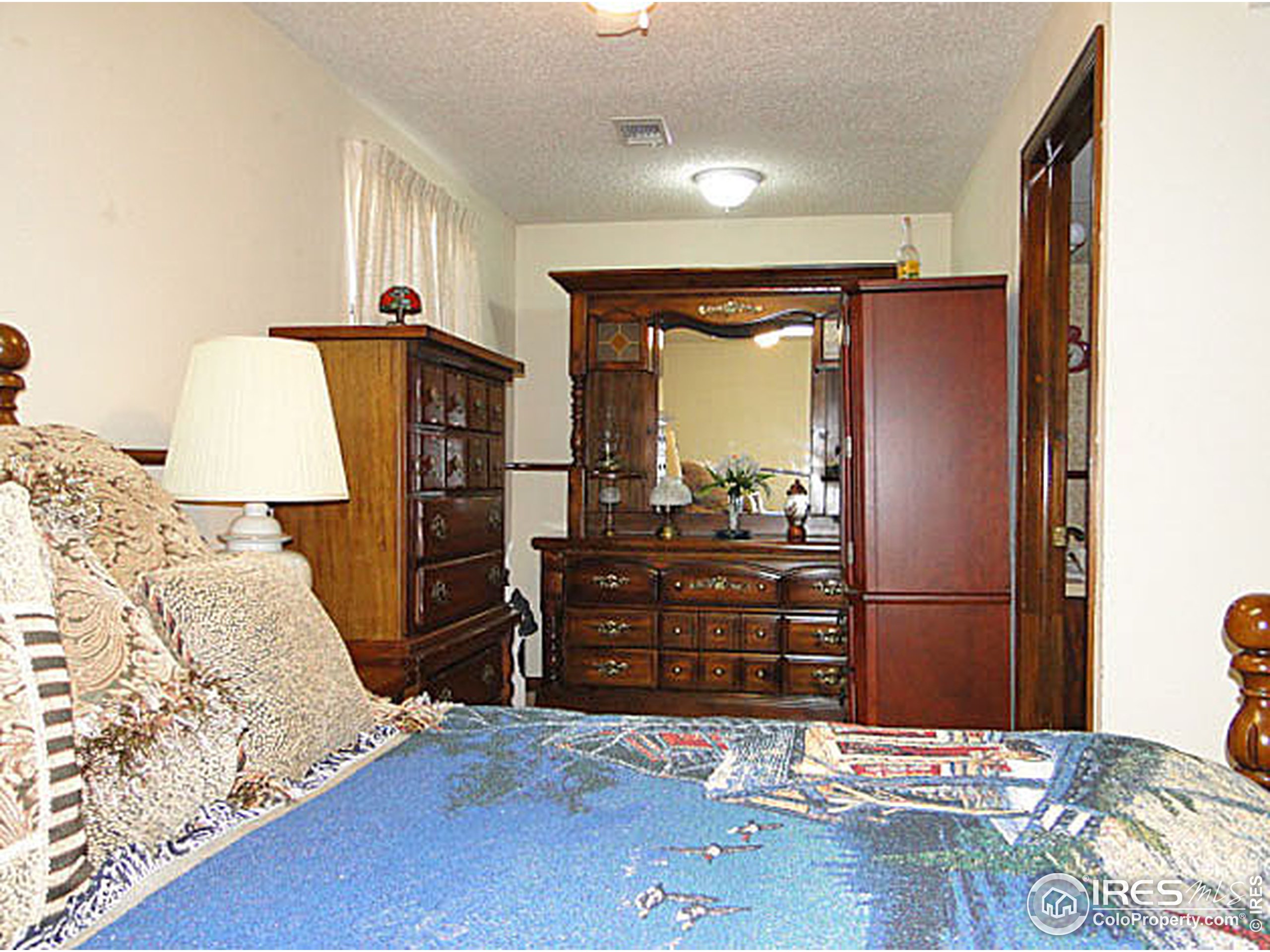 3334 34th Street Greeley, CO 80634 - Photo 19 of 25 a bedroom with a bed and a dresser