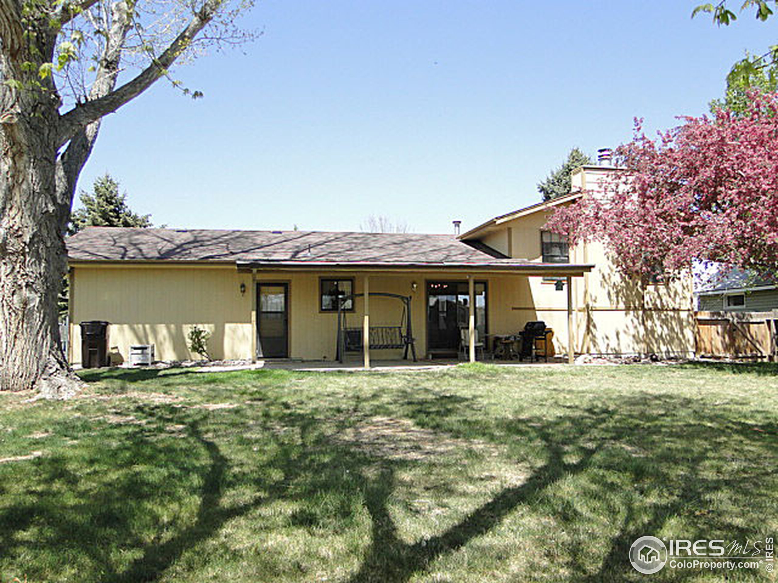 3334 34th Street Greeley, CO 80634 - Photo 21 of 25 a view of a house with a yard