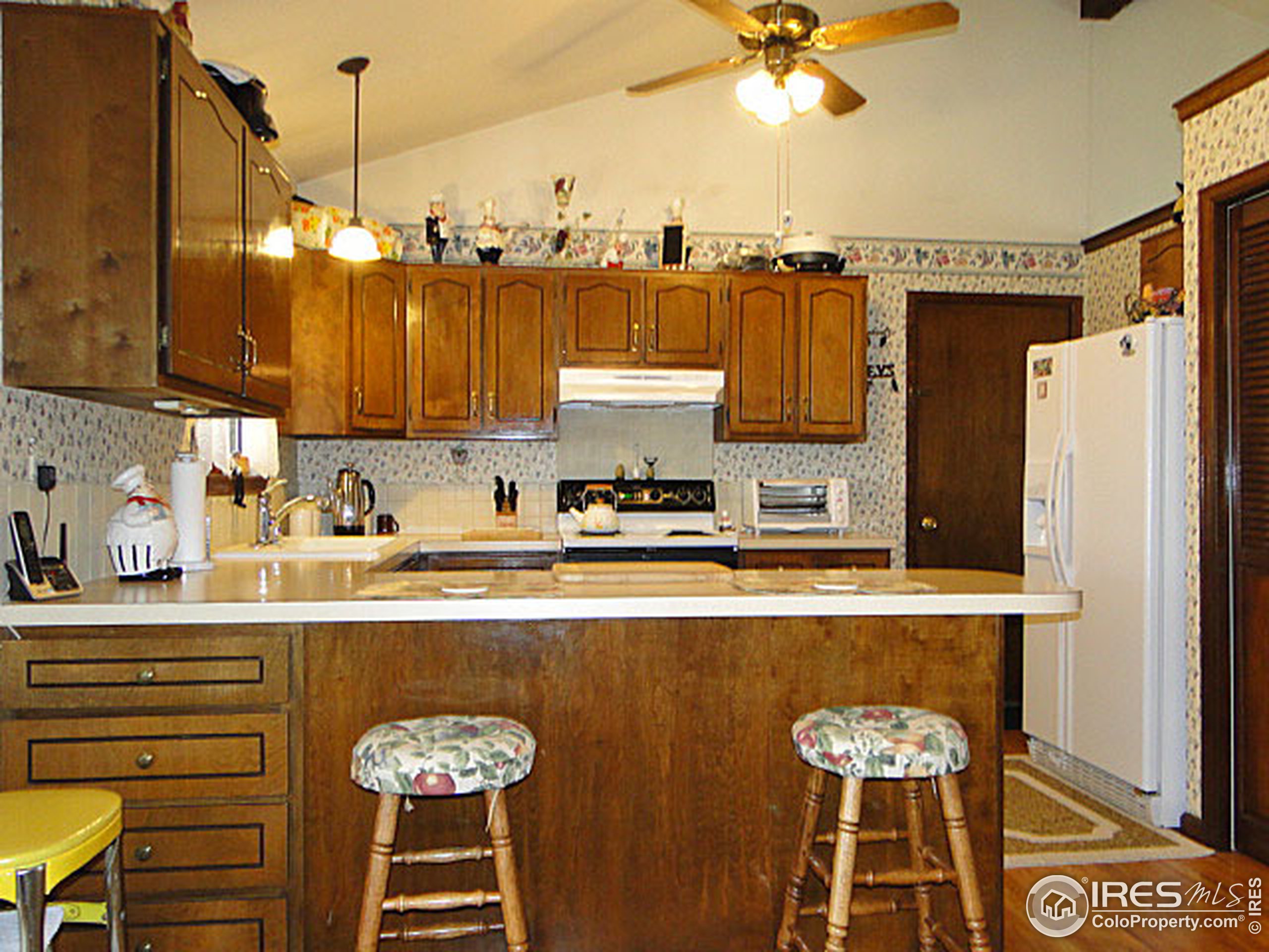 3334 34th Street Greeley, CO 80634 - Photo 3 of 25 a kitchen with stainless steel appliances granite countertop a sink a stove and a refrigerator