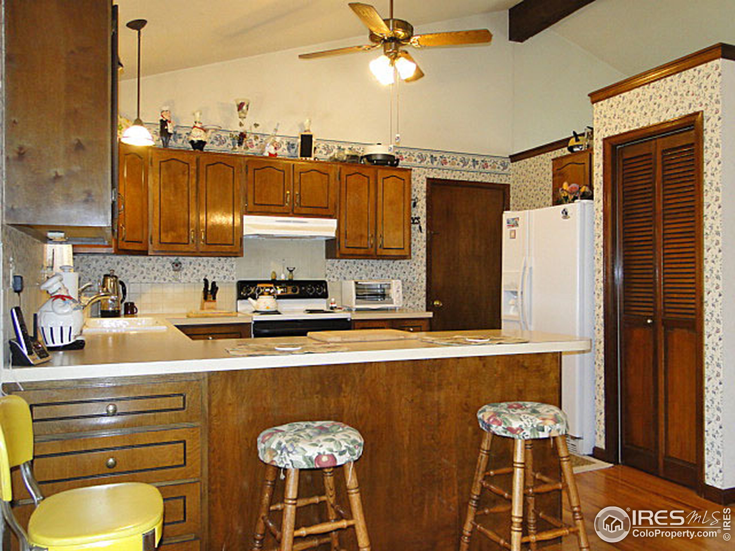 3334 34th Street Greeley, CO 80634 - Photo 8 of 25 a kitchen with stainless steel appliances granite countertop a sink a stove and a refrigerator