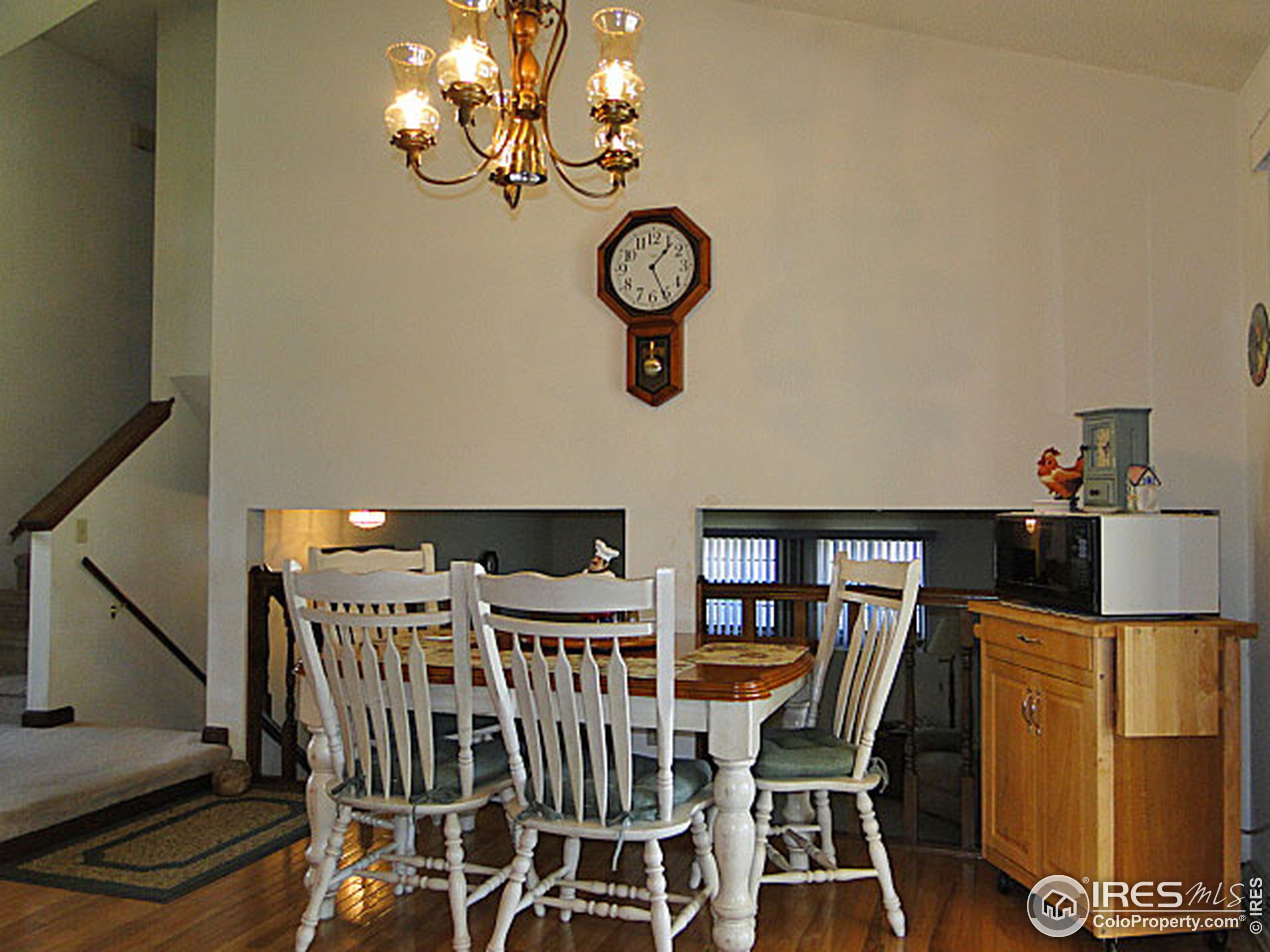 3334 34th Street Greeley, CO 80634 - Photo 10 of 25 a view of a dining room with furniture and wooden floor