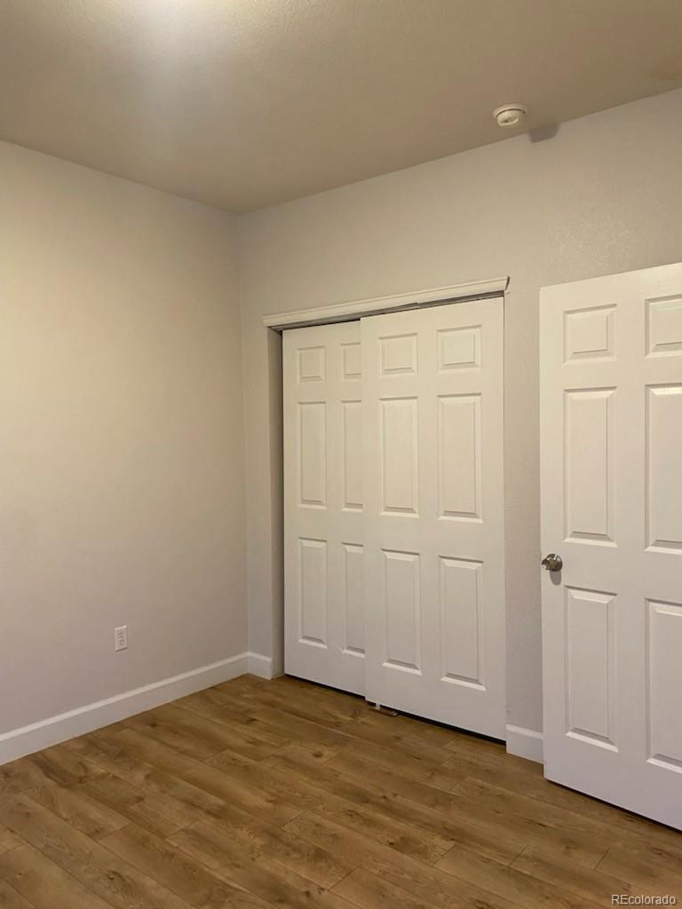 4582 West Alameda Avenue Denver, CO 80219 - Photo 13 of 17 a view of an empty room with wooden floor