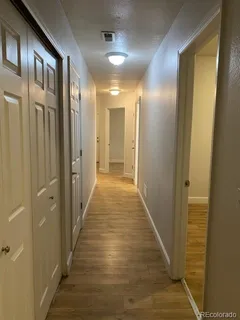 a view of an empty room and wooden floor