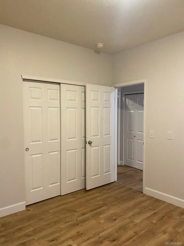 4582 West Alameda Avenue Denver, CO 80219 - Photo 10 of 17 a view of an empty room and wooden floor