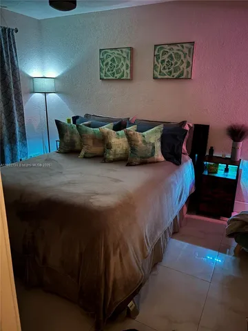 a bedroom with bed and window