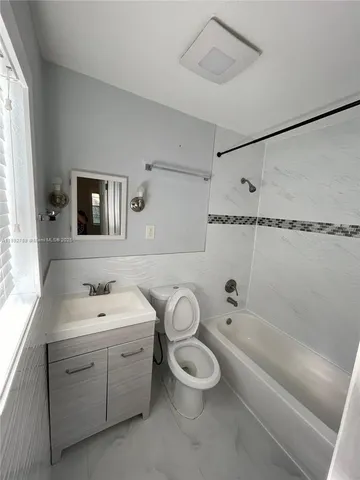 a bathroom with a double vanity sink toilet and shower