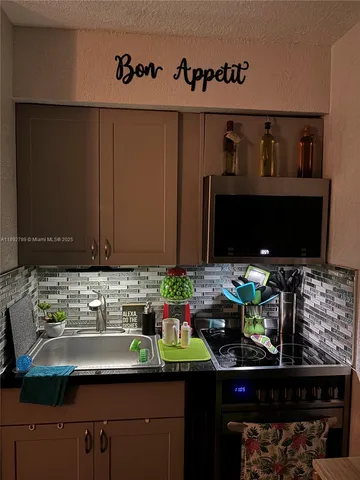 a kitchen with a sink and a stove in it