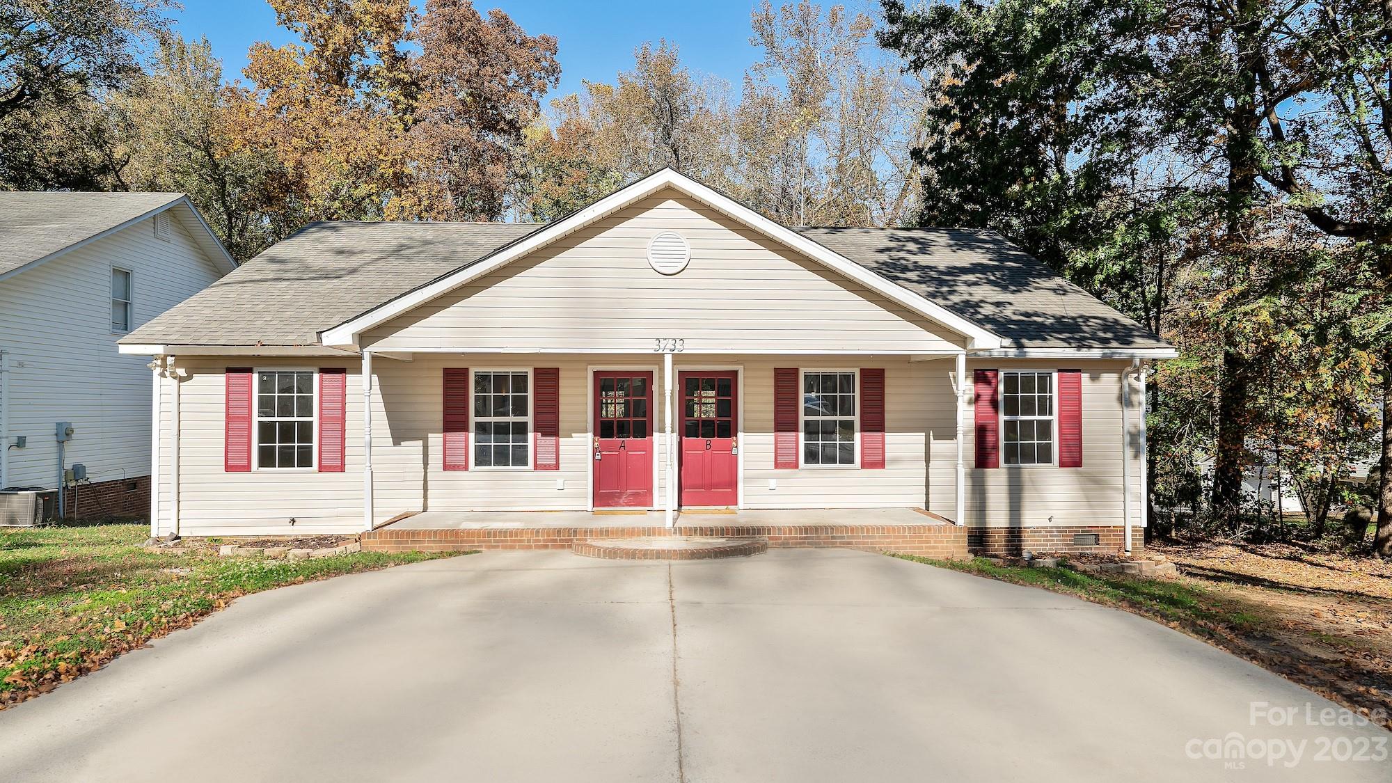 3733 Oakwood Road, Unit A Charlotte, NC 28269 - Photo 1 of 15 a front view of a house with a garage