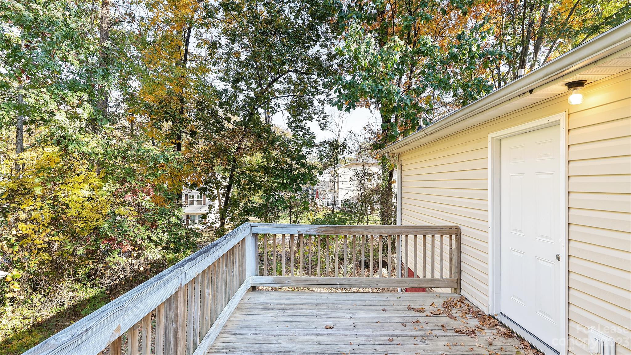 3733 Oakwood Road, Unit A Charlotte, NC 28269 - Photo 15 of 15 a balcony with wooden floor and fence