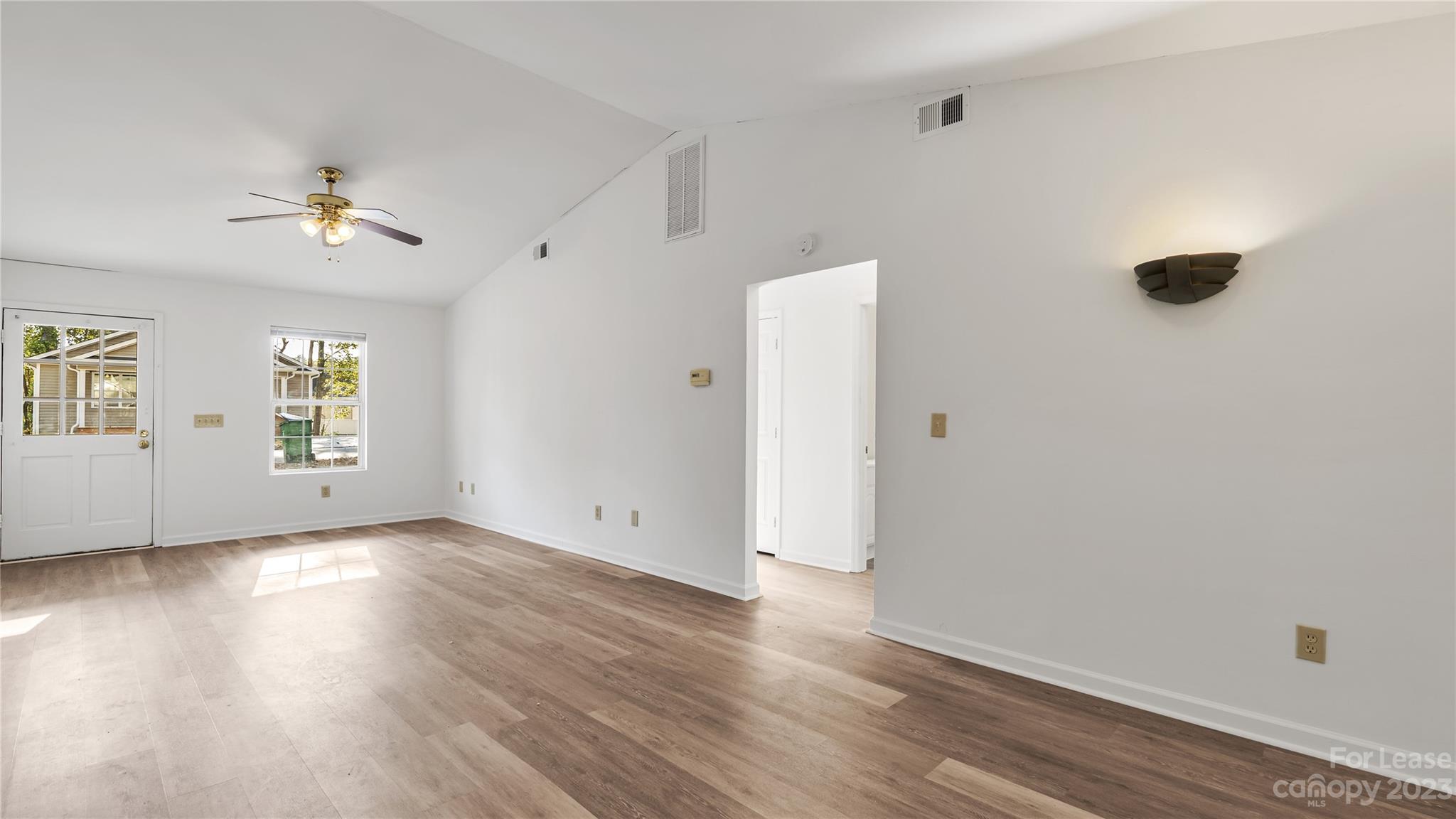 3733 Oakwood Road, Unit A Charlotte, NC 28269 - Photo 3 of 15 wooden floor in an empty room with a window