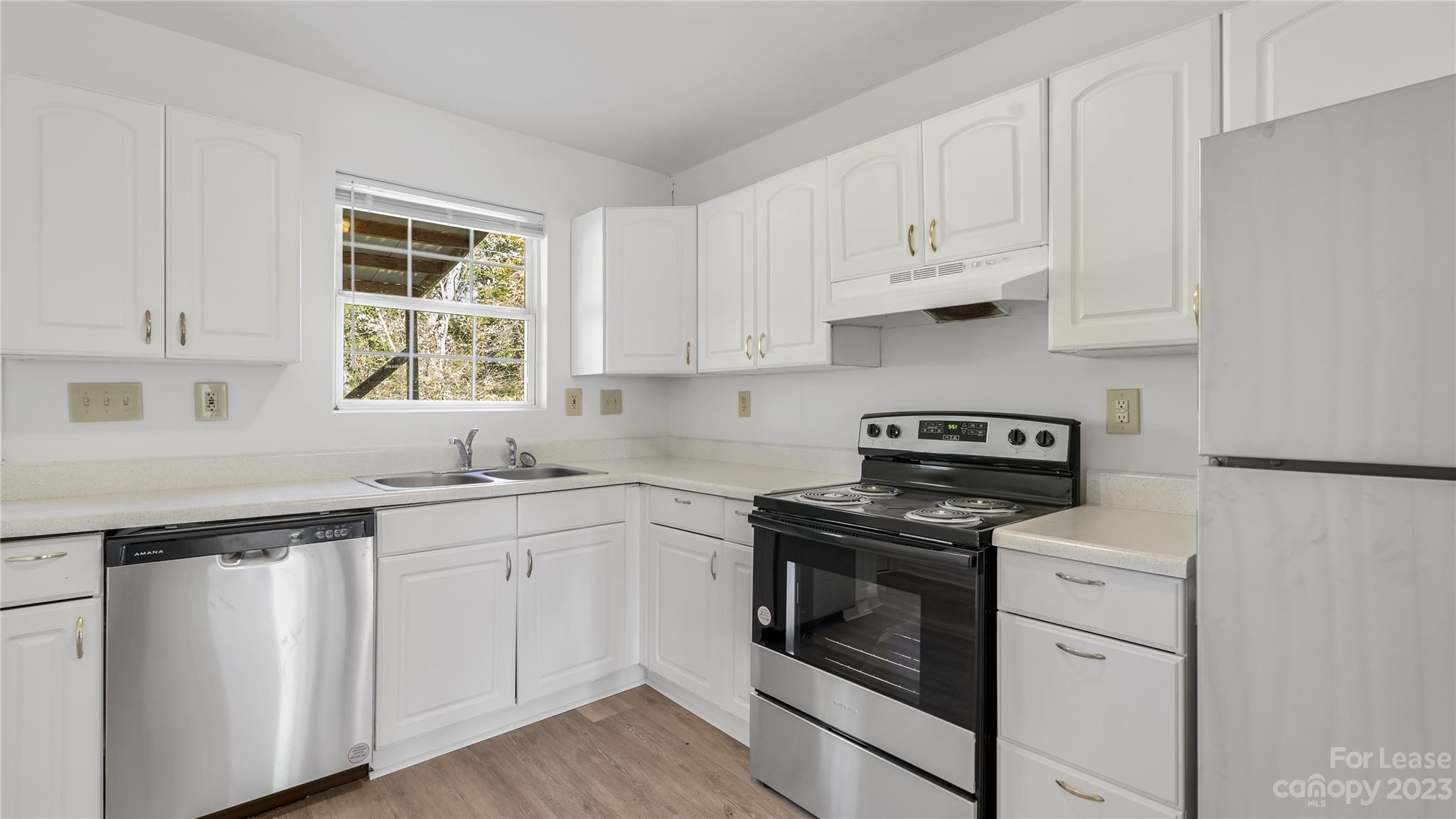 3733 Oakwood Road, Unit A Charlotte, NC 28269 - Photo 4 of 15 a kitchen with white cabinets and white appliances