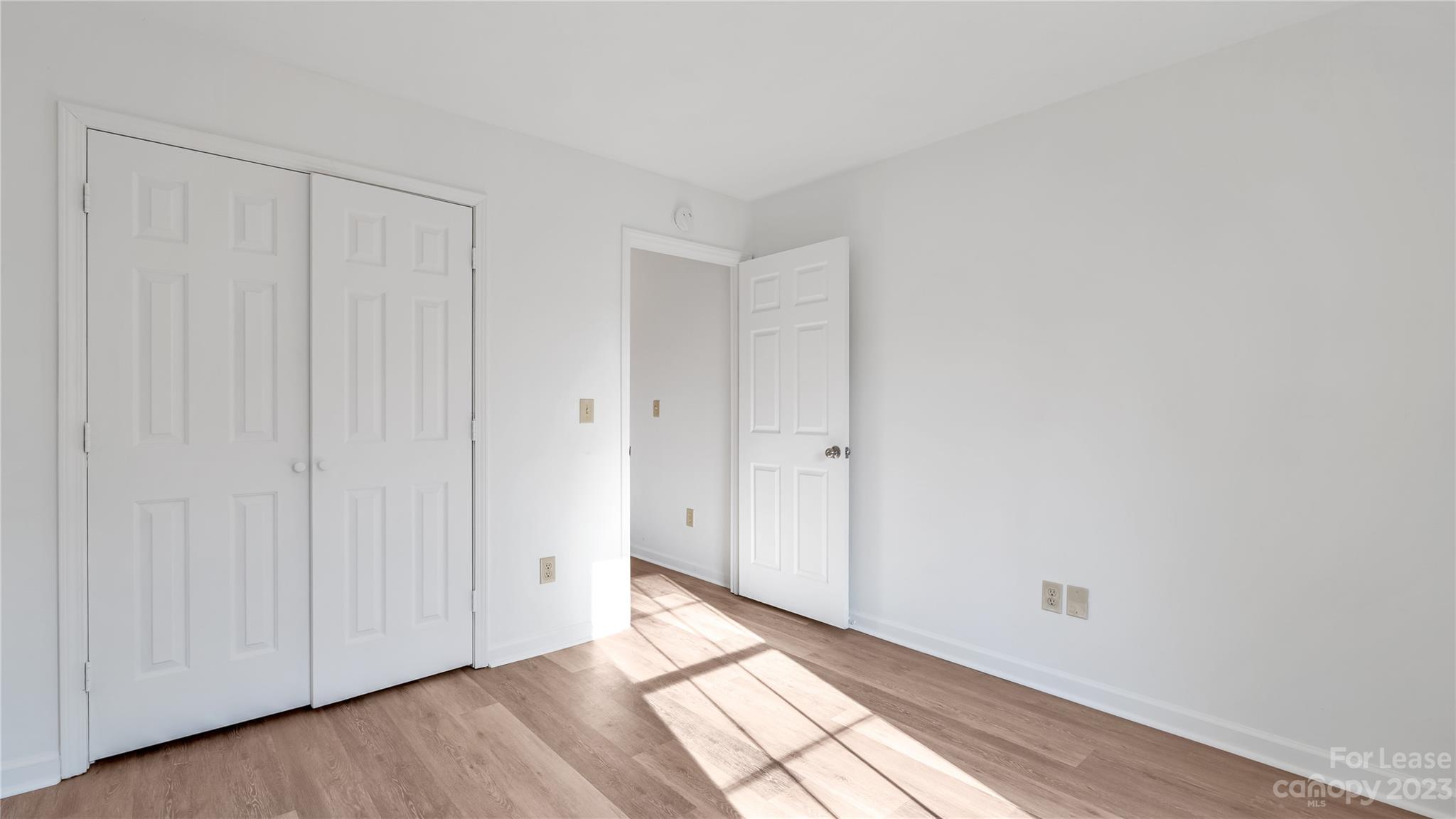 3733 Oakwood Road, Unit A Charlotte, NC 28269 - Photo 7 of 15 a view of an empty room and wooden floor