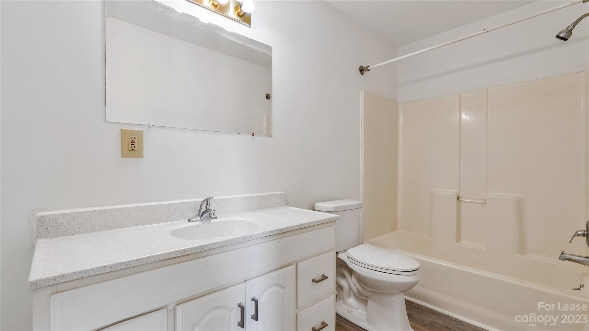 3733 Oakwood Road, Unit A Charlotte, NC 28269 - Photo 8 of 15 a bathroom with a sink a toilet and shower