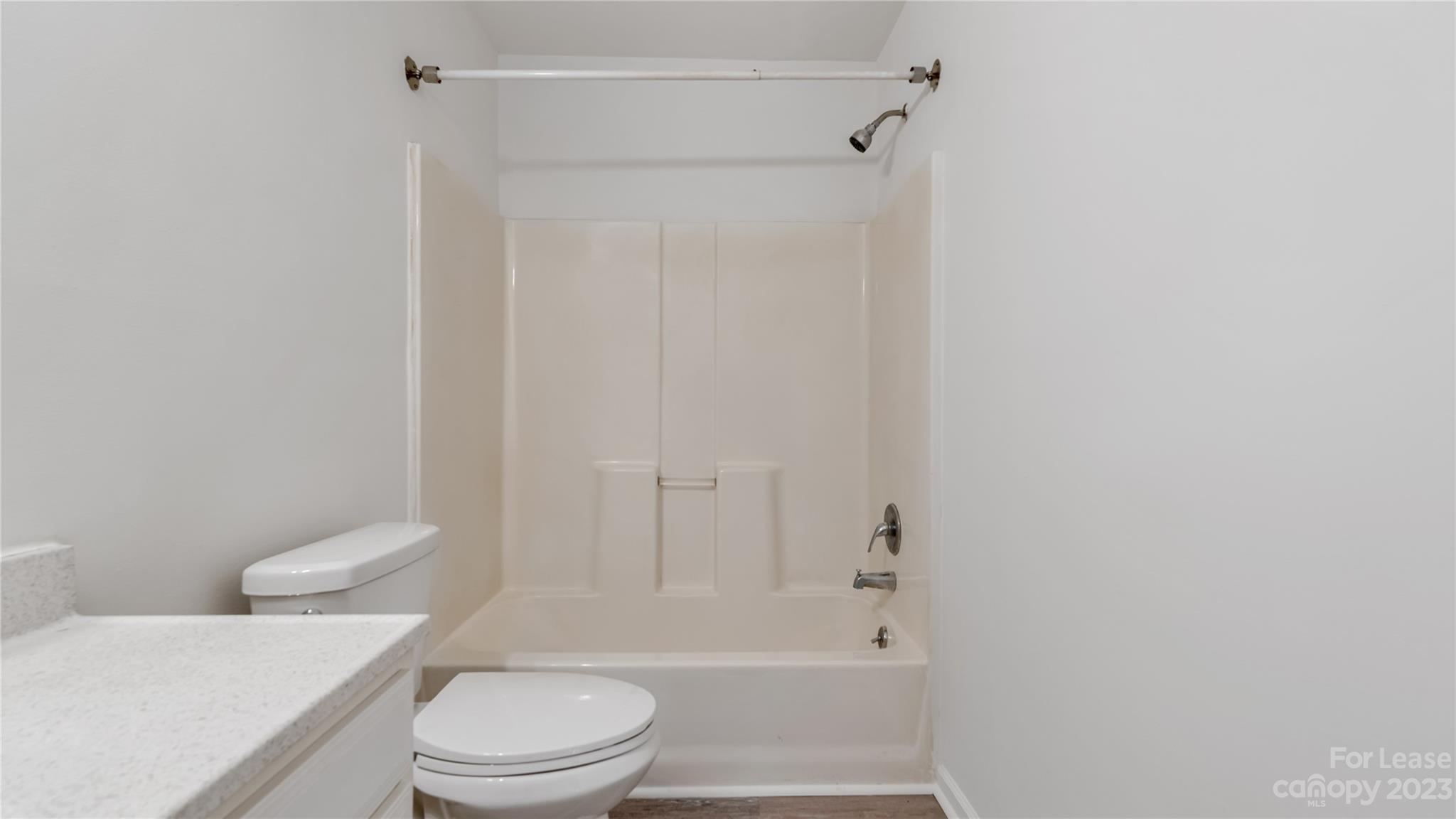 3733 Oakwood Road, Unit A Charlotte, NC 28269 - Photo 9 of 15 a white toilet sitting next to a bath tub