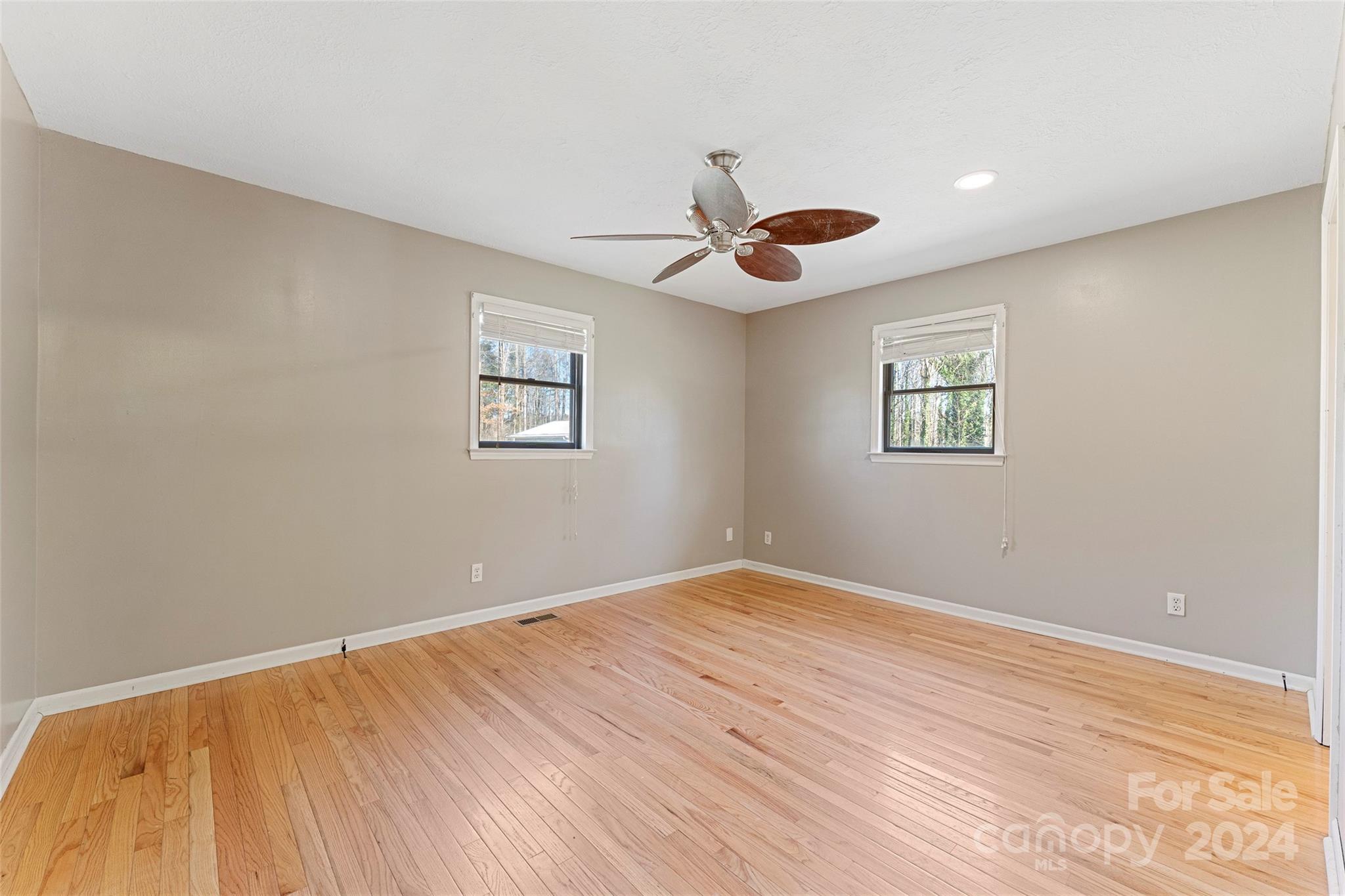 616 Oak Grove Road Flat Rock, NC 28731 - Photo 12 of 36 a view of an empty room with window and wooden floor